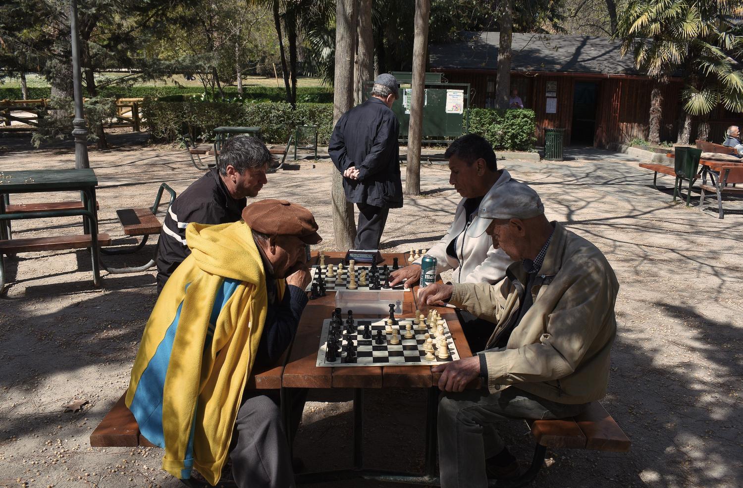 Ajedrez y reserva cognitiva Hombres mayores jugando al ajedrez en un parque, manteniendo la agilidad mental y la reserva cognitiva.